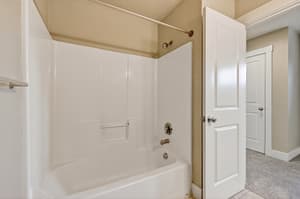 Bathroom with bathtub shower combo, neutral tiles at Glisan Townhomes, 17218-17298 NE Glisan St, Gresham, Oregon 97230
