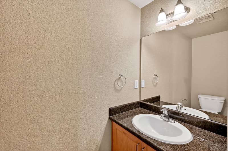 Bathroom with granite countertops at Glisan Townhomes