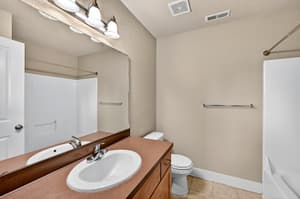 Bathroom with vanity mirror at Glisan Townhomes