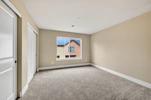 Bedroom with carpet flooring, large window at Glisan Townhomes, 17218-17298 NE Glisan St, Gresham, Oregon 97230