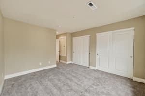 Bedroom with carpeted floor, double closets at Glisan Townhomes, 17218-17298 NE Glisan St, Gresham, Oregon 97230