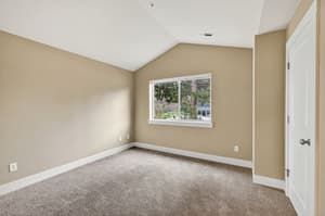 Bedroom with carpeted floor, large window at Glisan Townhomes, 17218-17298 NE Glisan St, Gresham, Oregon 97230