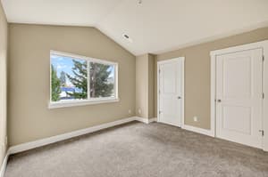 Bedroom with carpeted floor, large window at Glisan Townhomes, 17218-17298 NE Glisan St, Gresham, Oregon 97230