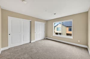 Bedroom with large window, carpeted floor at Glisan Townhomes, 17218-17298 NE Glisan St, Gresham, Oregon 97230