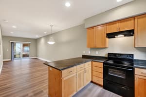 Kitchen with black appliances, wood cabinets at Glisan Townhomes, 17218-17298 NE Glisan St, Gresham, Oregon 97230