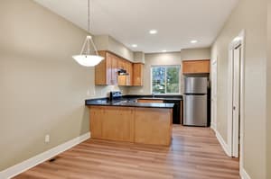 Kitchen with stainless steel appliances and granite countertops at Glisan Townhomes