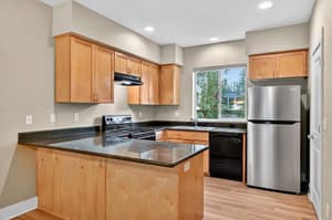 Kitchen with stainless steel appliances, granite countertops at Glisan Townhomes, 17218-17298 NE Glisan St, Gresham, Oregon 97230