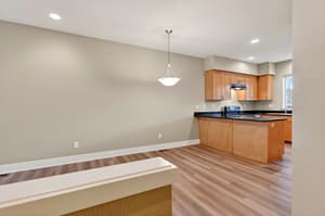 Kitchen with wood cabinets, black countertops at Glisan Townhomes, 17218-17298 NE Glisan St, Gresham, Oregon 97230