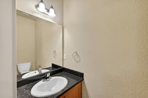 Bathroom with granite countertops, wall mounted mirror at Glisan Townhomes, 17218-17298 NE Glisan St, Gresham, Oregon 97230