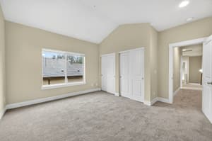Bedroom with carpeted floor, large window at Glisan Townhomes, 17218-17298 NE Glisan St, Gresham, Oregon 97230