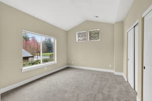 Bedroom with large window, neutral walls at Glisan Townhomes, 17218-17298 NE Glisan St, Gresham, Oregon 97230