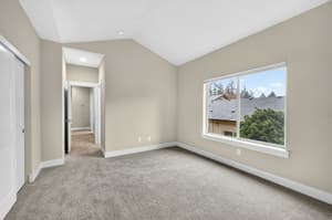 Bedroom with large window, carpeted floor at Glisan Townhomes, 17218-17298 NE Glisan St, Gresham, Oregon 97230
