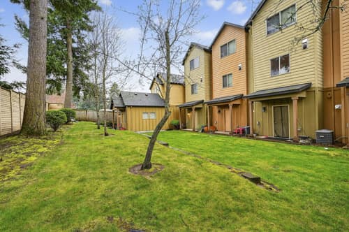 Exterior row of townhomes with landscaped garden at Glisan Townhomes