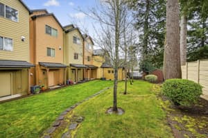 Exterior with large tree, greenery at Glisan Townhomes, 17218-17298 NE Glisan St, Gresham, Oregon 97230