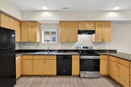 Kitchen with stainless steel appliances at Glisan Townhomes